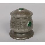 An Arts & Crafts pewter tobacco jar and cover in the manner of Archibald Knox. Decorated with