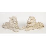 A pair of terracotta white crackle glazed models of recumbent lions. 58cm long. Condition report