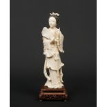 A 19th century Chinese carved ivory figure of Guanyin. Her hair stained black, stood holding a fan