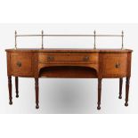 A 19th century mahogany sideboard with brass gallery rail. Having strung inlay and raised on
