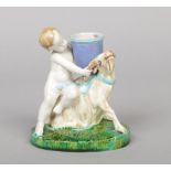 A Victorian Minton majolica figural spill vase. Formed as a putti and a ram raised on an oval