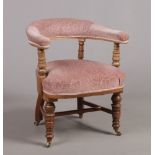 A Victorian carved mahogany and upholstered tub chair.