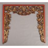 An early 20th century Chinese carved, pierced and lacquered wood pelmet. Ornamented with stylized