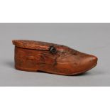 A 17th century Continental treen snuff box formed as a clog. Decorated with a coat of arms and