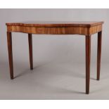 A George III mahogany serpentine serving table. Banded in satinwood, with strung inlay and raised on