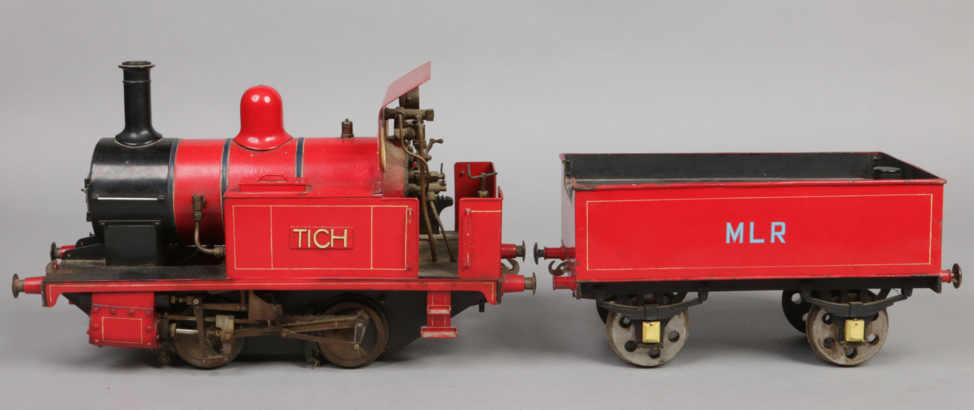 A 3.5" gauge 0-4-0 live steam tank engine and tender.  With red livery, the engine named Tich and