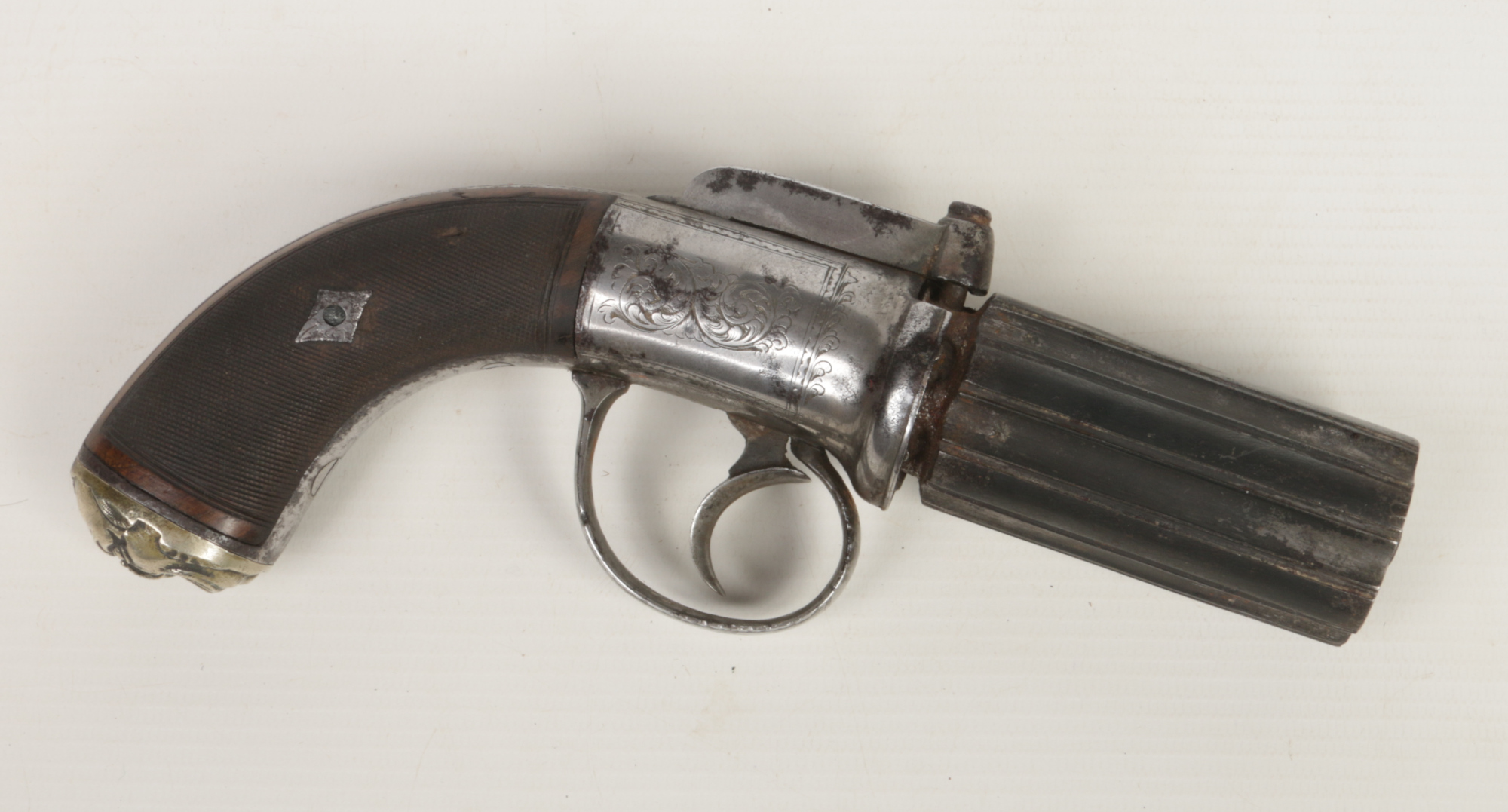 A mid 19th century six-shot pepperbox revolver. With fluted barrels, engraved round action,