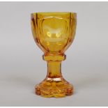 A 19th century Bohemian amber cut glass goblet. Etched with three panels depicting a dog, a horse