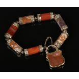 A Victorian pinchbeck mounted agate bracelet with shield shaped mourning locket containing a plait