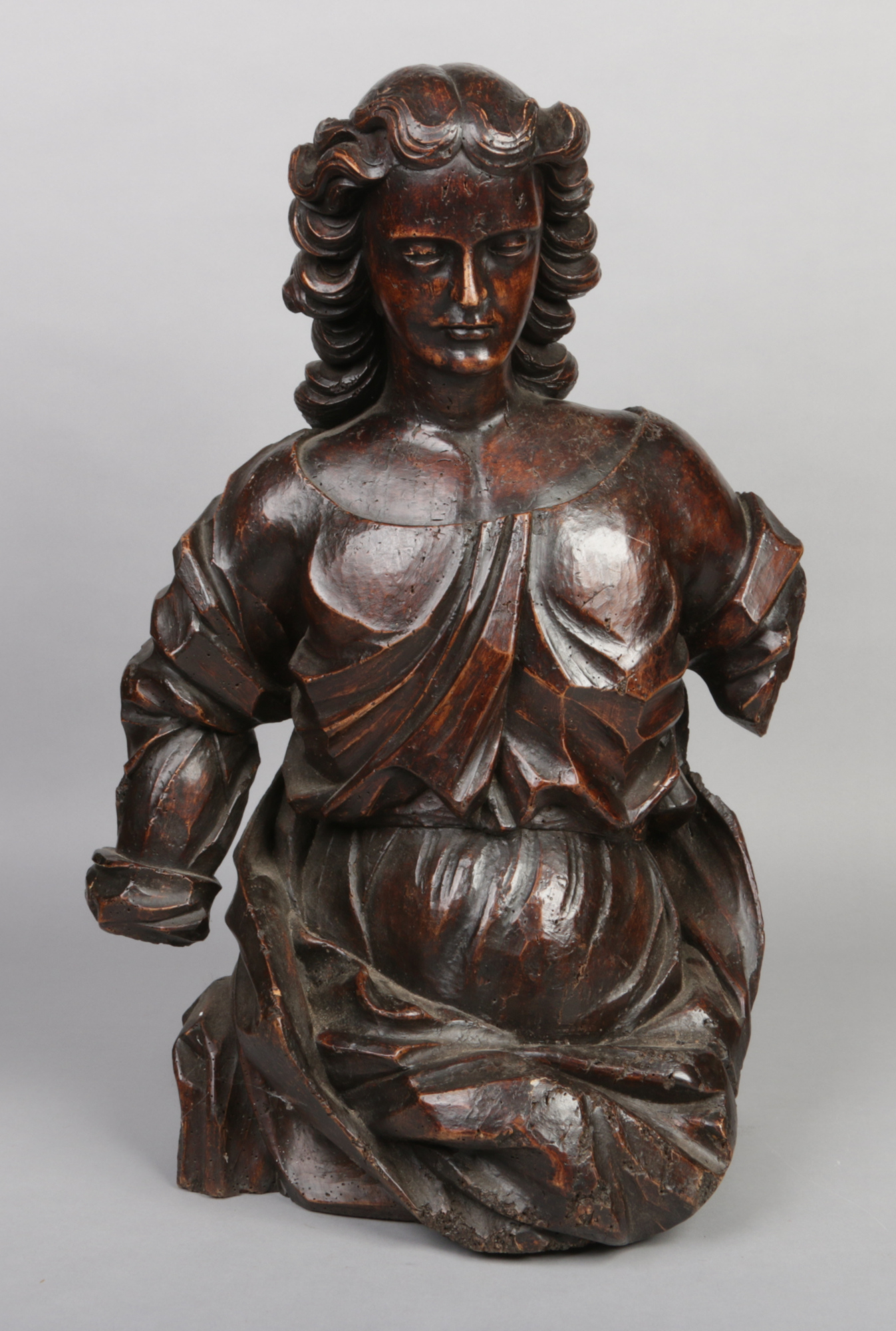 An 18th century Continental carved walnut three quarter length statue of a maiden, 72cm high.