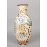 A large Royal Cauldon baluster vase with ribbed shoulder. Tube lined and glazed with stylized