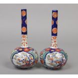 A pair of 20th century Japanese Imari octagonal bottle vases, 21.5cm.Condition report intended as