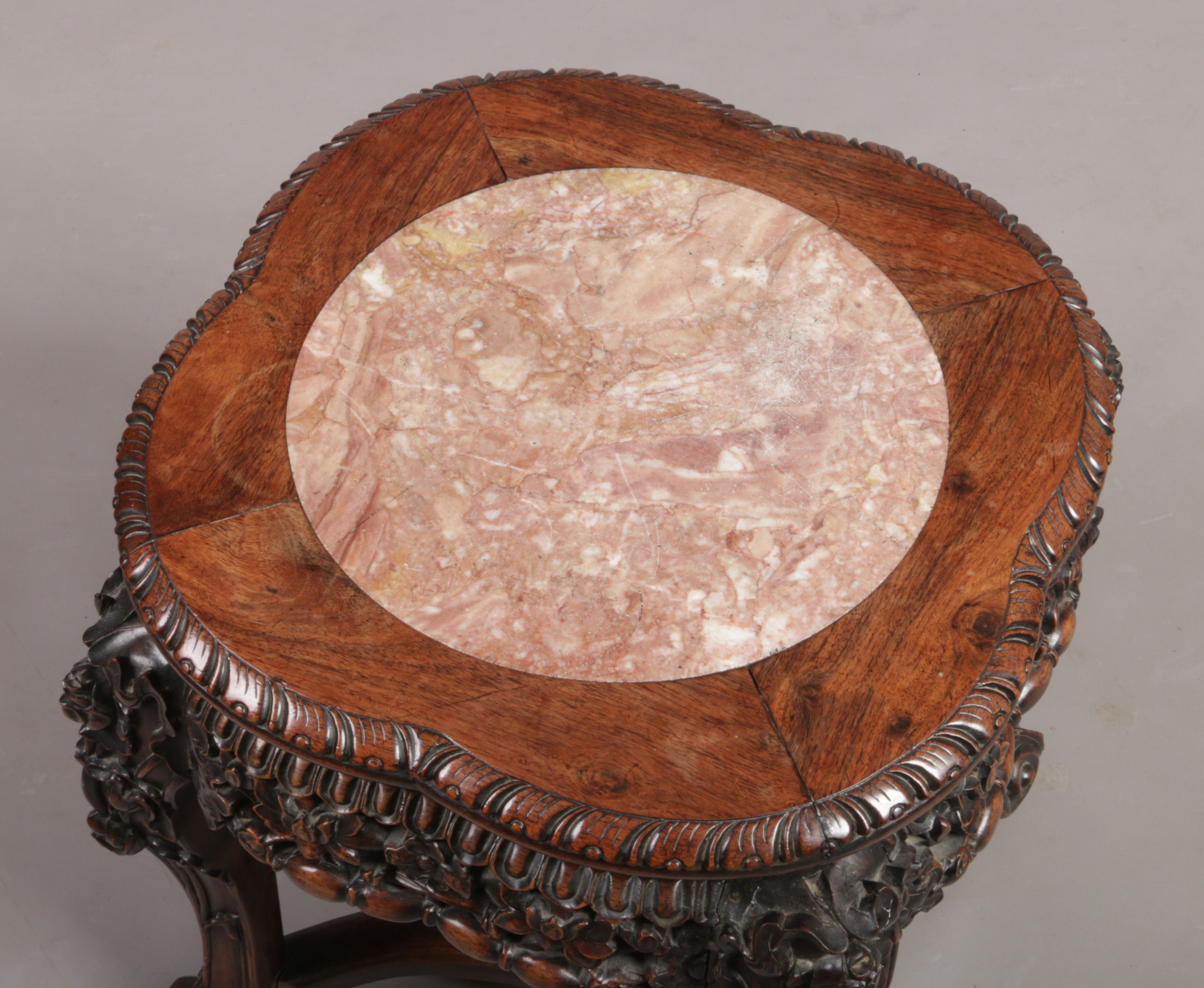 A 19th century Chinese hardwood and pink marble vase stand. With gadrooned quatrefoil top, foliate - Image 2 of 2