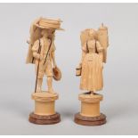 A pair of Continental carved boxwood figures of street traders, 17cm.