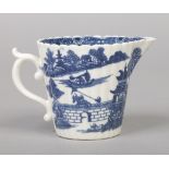 A Caughley cream jug of fluted tapering form and with double scrolling handle. Printed in underglaze