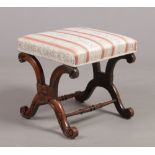 A Victorian mahogany X-frame stool with scroll supports and turned cross stretchers, 44cm x 43cm.