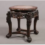 A 19th century Chinese hardwood and pink marble vase stand. With gadrooned quatrefoil top, foliate