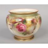 A Royal Worcester jardiniere. Lobed and with moulded border, painted with a continuing band of