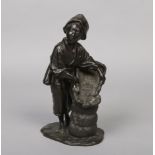 A Japanese Meiji period patinated bronze figure. Formed as a woman harvesting rice. Seal mark to the