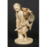 A Japanese Meiji period carved ivory okimono formed as a street hawker with baskets. Stood strapping