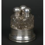 A George V nest of three cut glass scent bottles with silver tops and stand. Assayed Birmingham