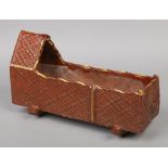 A 19th terracotta slipware cradle with moulded lattice panels, 46cm long.Condition report intended