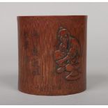 A Chinese bamboo bitong. Carved in light relief with a figure and with incised character