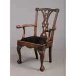 A George III Irish mahogany elbow chair. With pierced splat, ball and claw arm terminals and