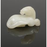 A 19th century Chinese small carved pale celadon jade model of a recumbent horse, 4.75cm.Condition