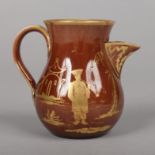 A Brameld brown glazed earthenware baluster sparrow beak cream jug with reeded strap handle. Painted