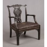 A 19th century Chippendale style large carved mahogany elbow chair. With pierced baluster shaped