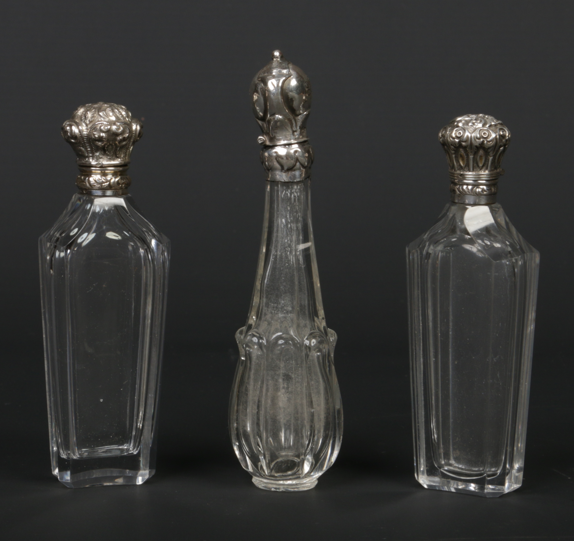 Three 19th century French silver mounted crystal scent bottles. Largest 11cm.Condition report