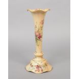 A Royal Worcester trumpet shaped blushware vase. Decorated with flowers and gilded. Printed puce