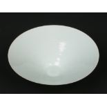 A Chinese conical bowl of very finely potted form. Decorated in pale celadon glaze and lightly