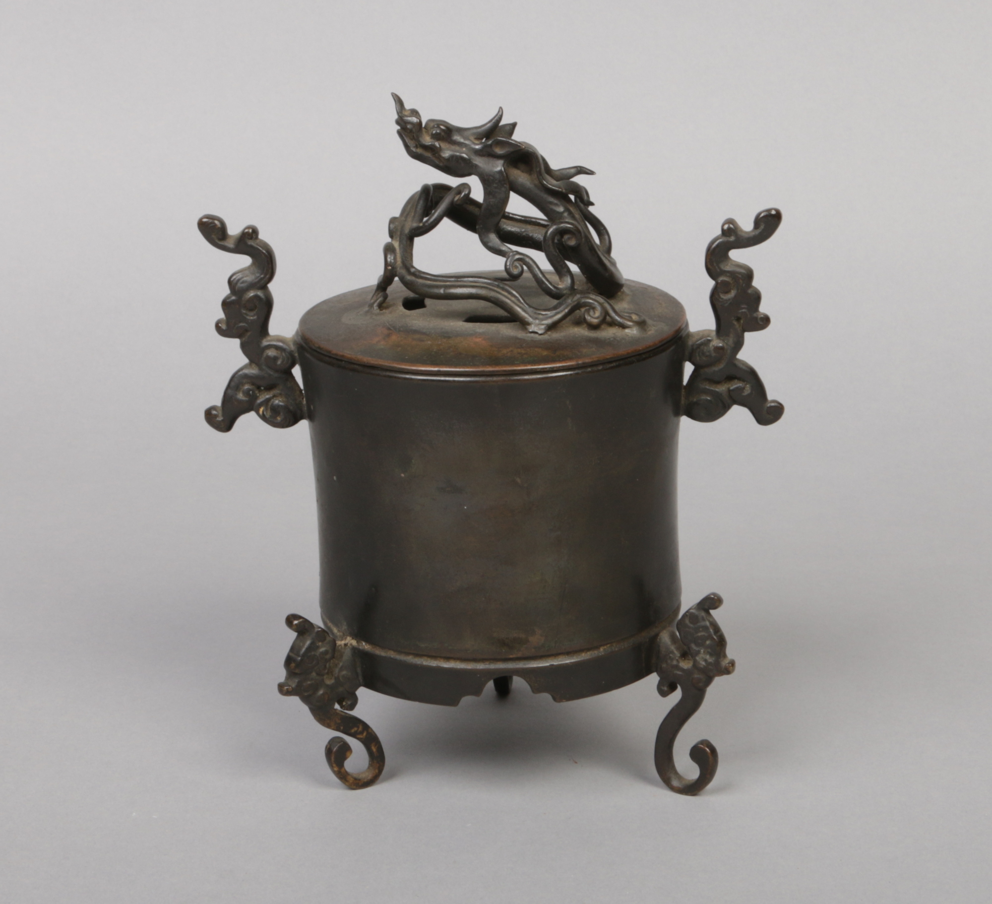 A 19th century Chinese bronze censer. With a scrolling dragon knop, cloud scroll handles and