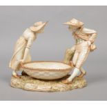 A Royal Worcester figural blushware centrepiece by James Hadley. Modelled as a lady and gent