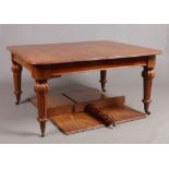 A Victorian mahogany wind-out dining table. Raised on reeded tapering supports, having centre leg