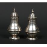 A pair of Victorian silver pepperettes of baluster form by Charles Stuart Harris. Assayed London