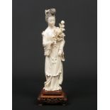 A 19th century Chinese carved ivory figure of Guanyin. Wearing long flowing robes, holding a