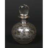 A 19th century globular glass scent bottle and stopper with silver overlay decoration, 9.5cm.