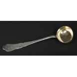 A 19th century French silver soup ladle with gilt bowl and engraved scrollwork to the terminal.
