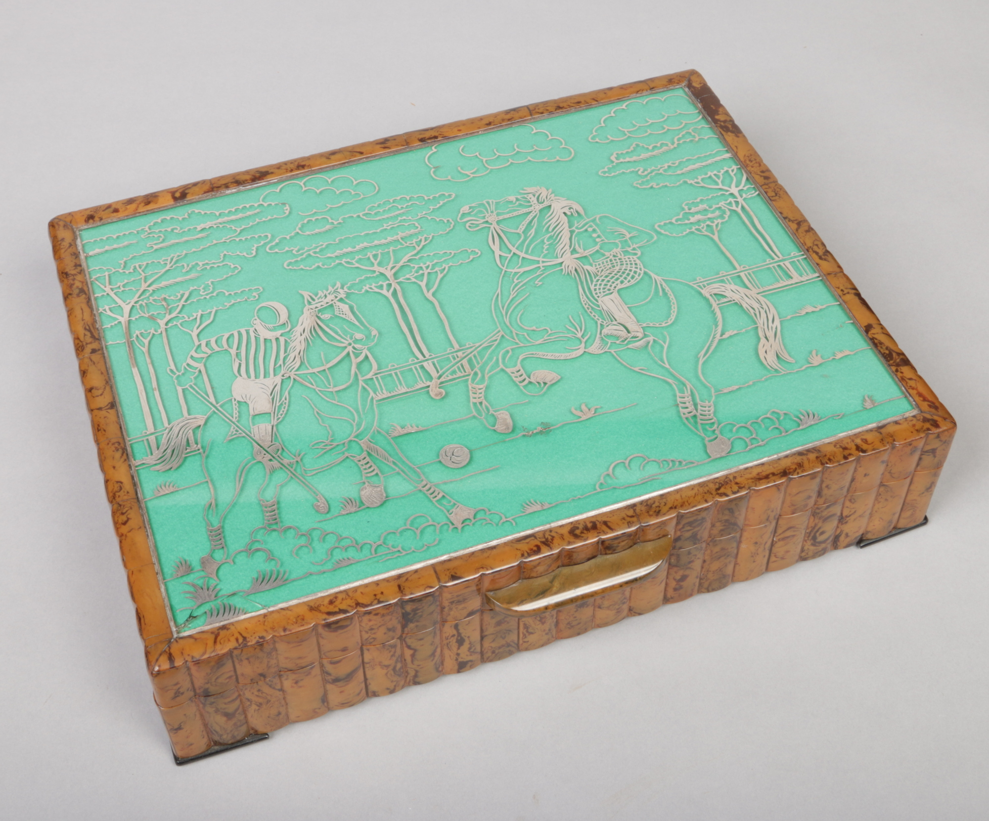 An Italian Art Deco Bakelite / Catalin mounted games compendium. The top with silver overlay