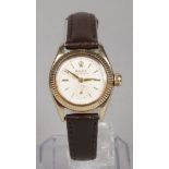 A ladies 9 carat gold cased Rolex Oyster Perpetual wristwatch. With cream dial, baton markers and