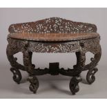 A 19th century Anglo-Indian carved mahogany demi-lune serving table raised on scrolling supports.