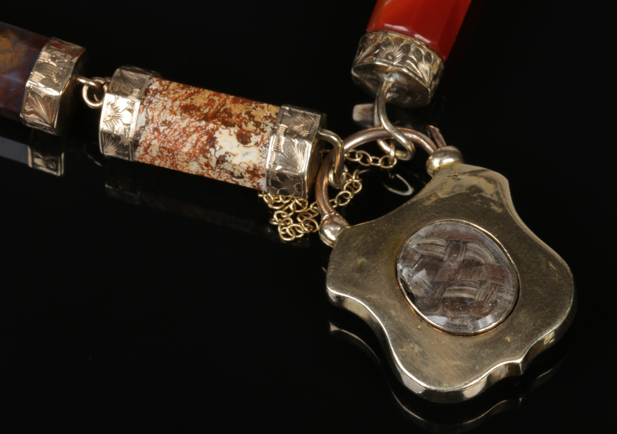 A Victorian pinchbeck mounted agate bracelet with shield shaped mourning locket containing a plait - Image 2 of 2