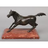 A 19th century Continental patinated bronze sculpture of a stallion raised on a bevelled rectangular