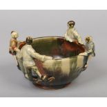 A Japanese Sumida Gawa bowl. Decorated in drip glazes and applied with four figures to the rim, 13cm