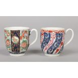 Two Worcester coffee cups with grooved loop handles. One decorated with the Queen Charlotte