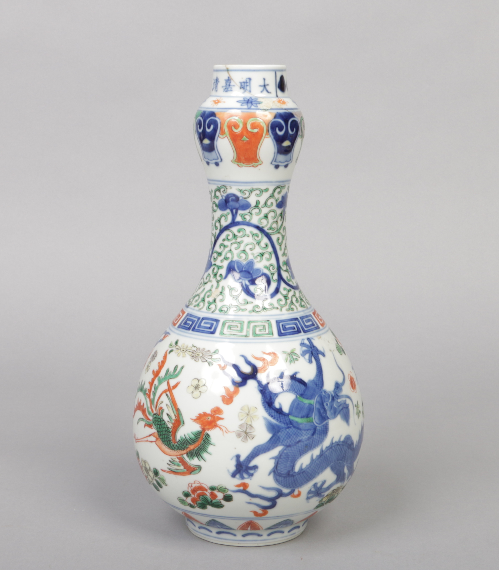 A Chinese Wucai glazed gourd shaped bottle vase. Decorated with a pair of dragons and phoenix