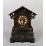 A 19th century Black Forest cuckoo mantel clock. With triangular pediment, acanthus scrolling